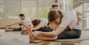 a group of people doing yoga in a room