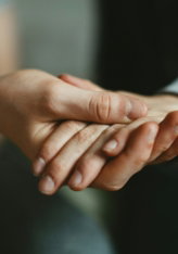 person-holding-babys-hand.jpg person holding babys hand
