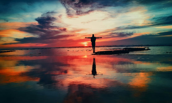 silhouette-of-person-standing-on-rock-surrounded-by-body-of-water.jpg silhouette of person standing on rock surrounded by body of water
