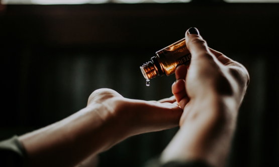 person-holding-amber-glass-bottle.jpg person holding amber glass bottle